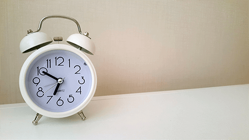 alarm clock sitting on desk